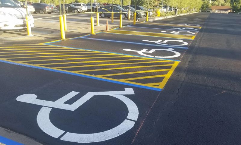 Freshly restriped parking lot with crisp stall lines and crosshatching